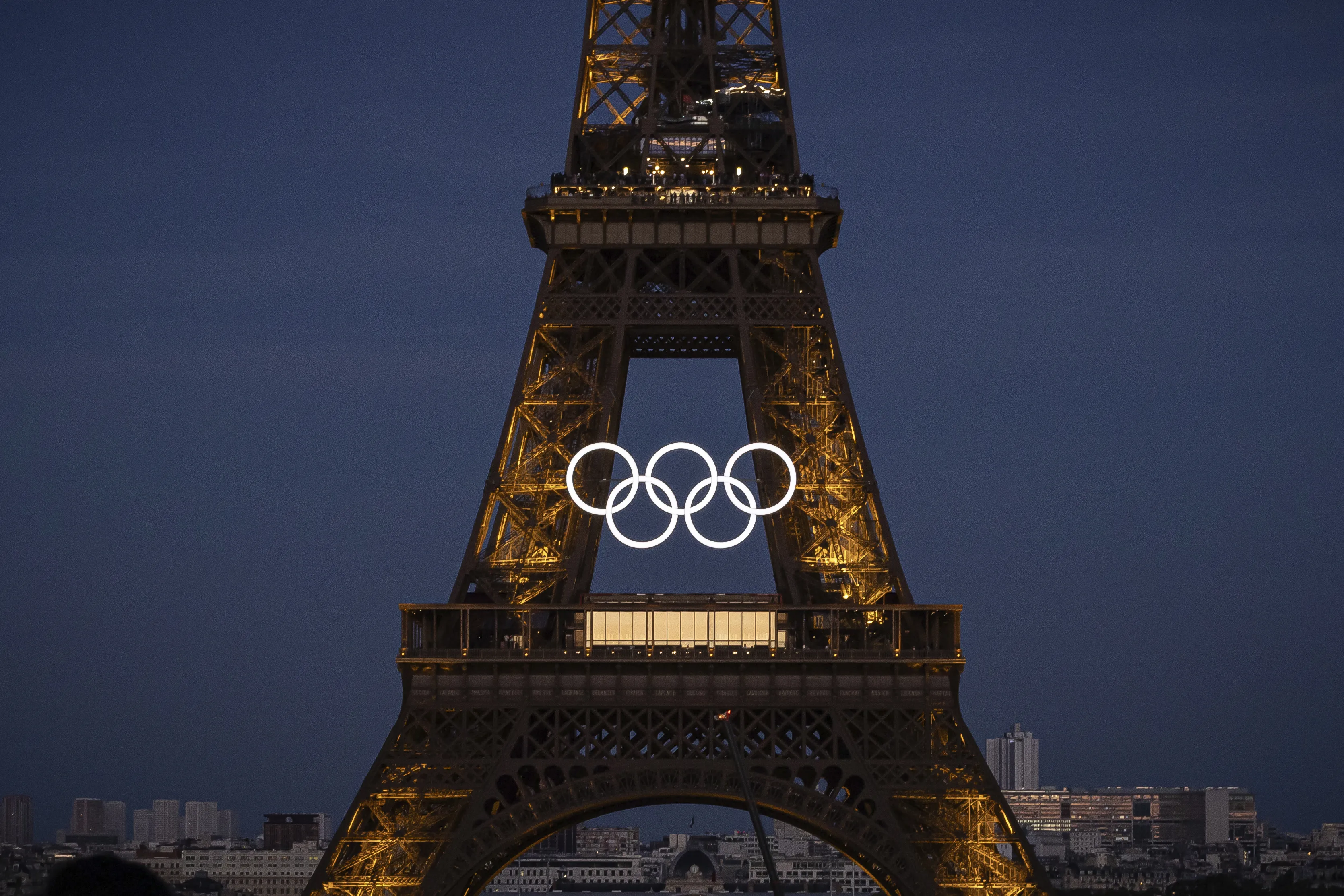 The Olympic rings are seen on the Eiffel Tower Friday, June 7, 2024, in Paris. The Paris Olympics organizers mounted the rings on the Eiffel Tower on Friday as the French capital marks 50 days until the start of the Summer Games. The 95-foot-long and 43-foot-high structure of five rings, made entirely of recycled French steel, will be displayed on the south side of the 135-year-old historic landmark in central Paris, overlooking the Seine River. (AP Photo/Aurelien Morissard)